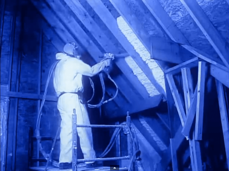 Technician spraying spray foam insulation