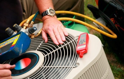 Technician troubleshooting a heating and air conditioning issue